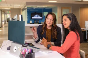 two women looking at computer at tax services for 1120-h tax form