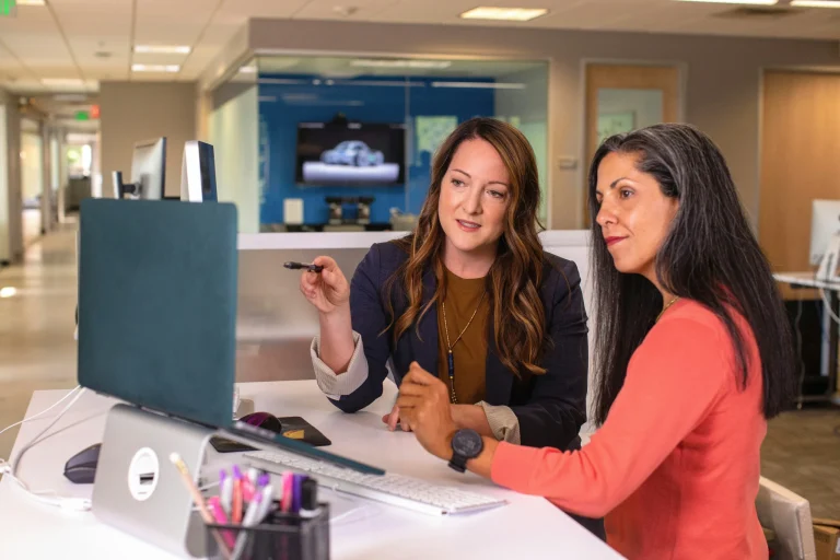 two women looking at computer at tax services for 1120-h tax form