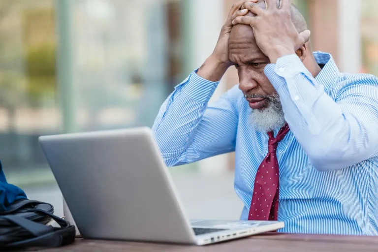 man with hands on head