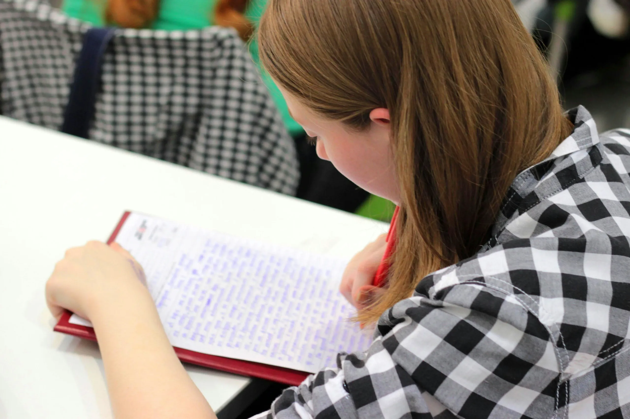girl writing down notes 