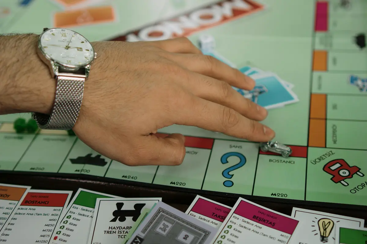 man moving Board game piece