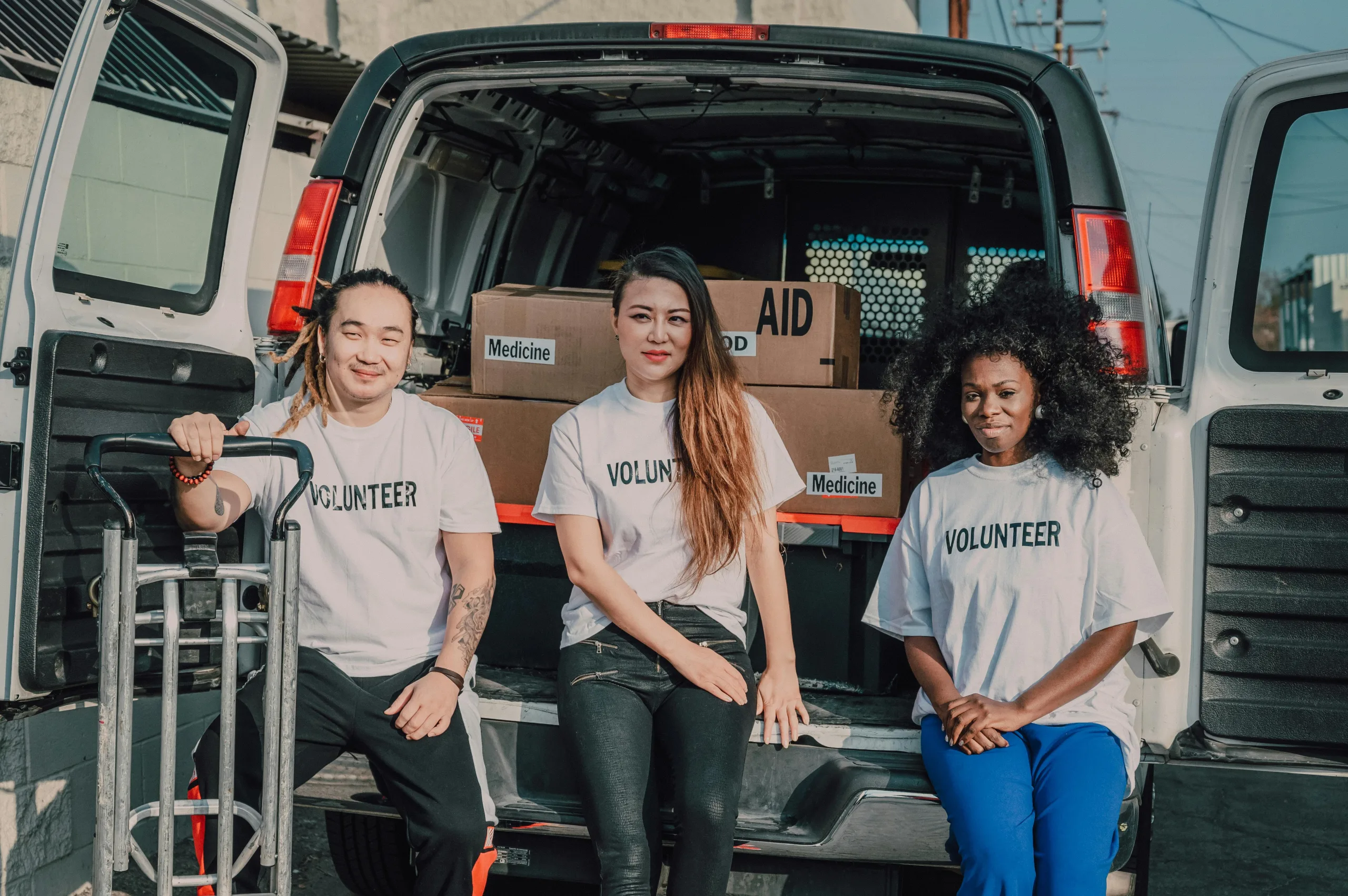 friends sitting on the back on a van