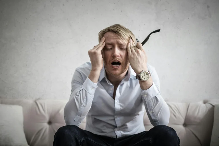 man with hands on head