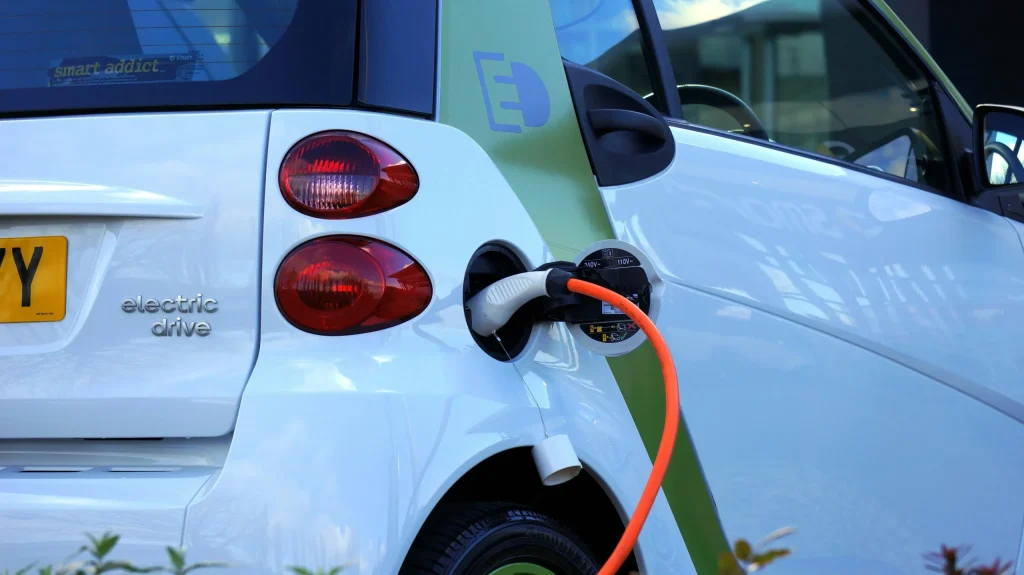 An electric vehicle is being charged, as it is eligible for Clean Energy CA Rebate.