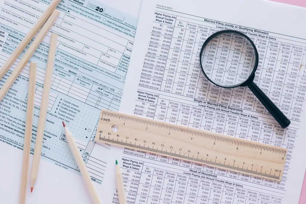 A chart, magnifying glass, ruler, and pencils