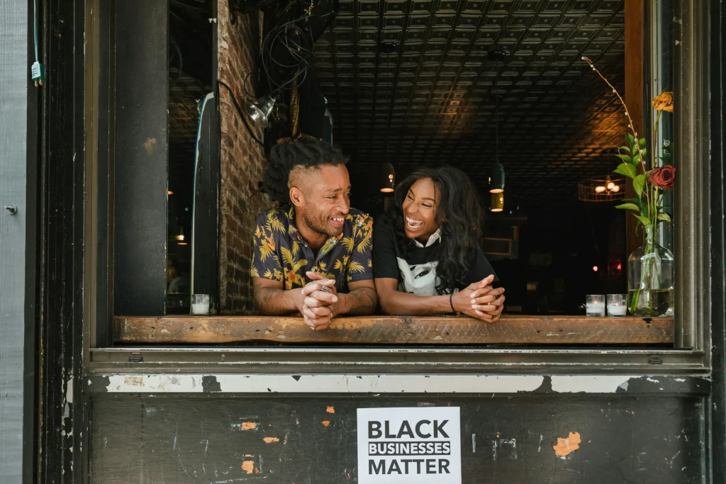 Two business partners having a laugh in their storefront.