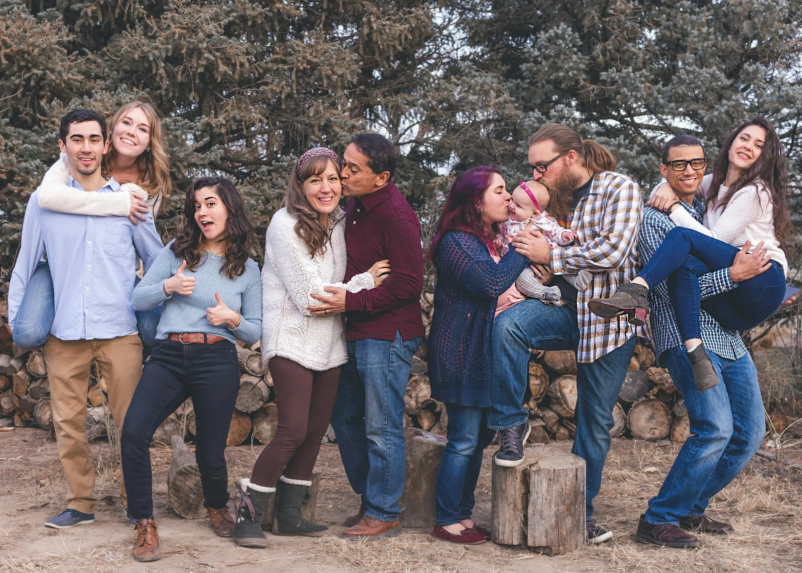 A group of 10 people of varied ages are gathered like a family for a photo.