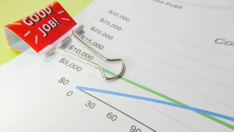 A chart with a paper clip holding it to other documents.