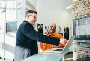 A sales person is helping a customer find the product they need in the store.