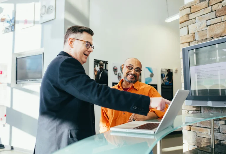 A sales person is helping a customer find the product they need in the store.