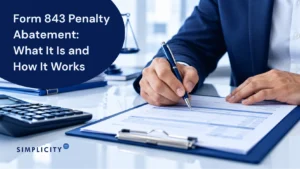 Image of person completing form 843 penalty abatement paperwork with pen